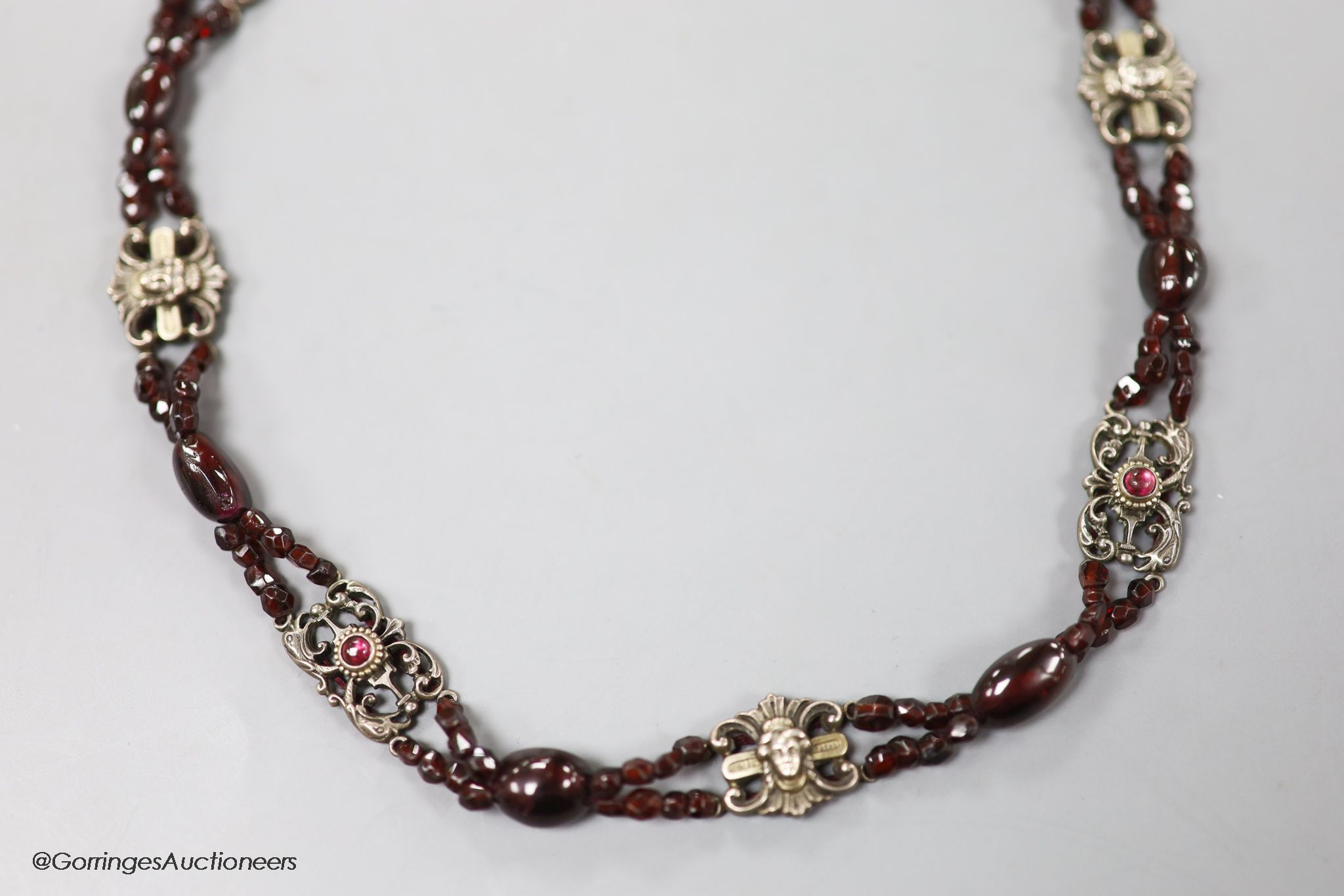 An early 20th century white metal, garnet and red paste? set choker necklace, 40cm.